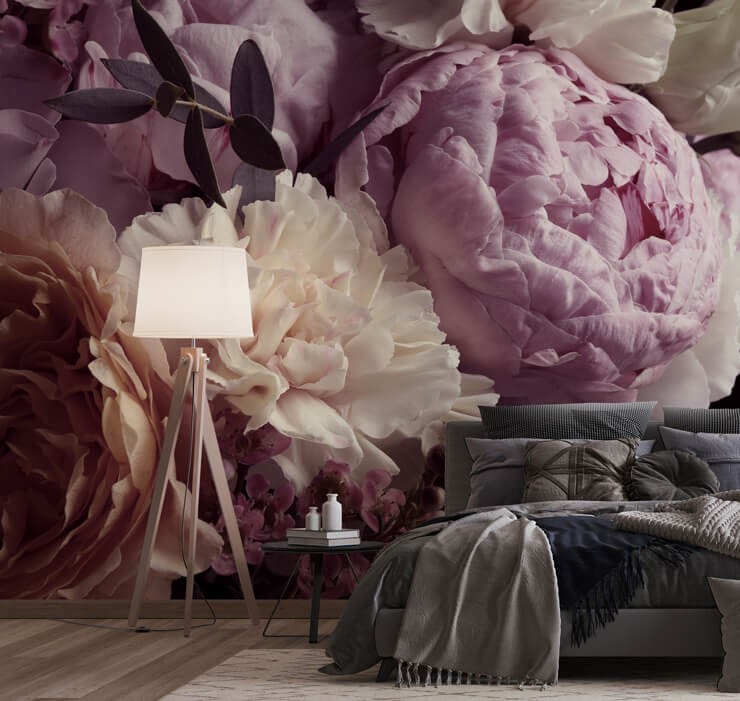 dark floral wallpaper in bedroom with grey bed