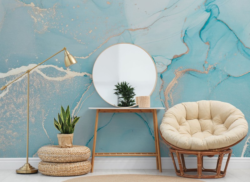 Blue marble effect mural in a living room with curved furniture