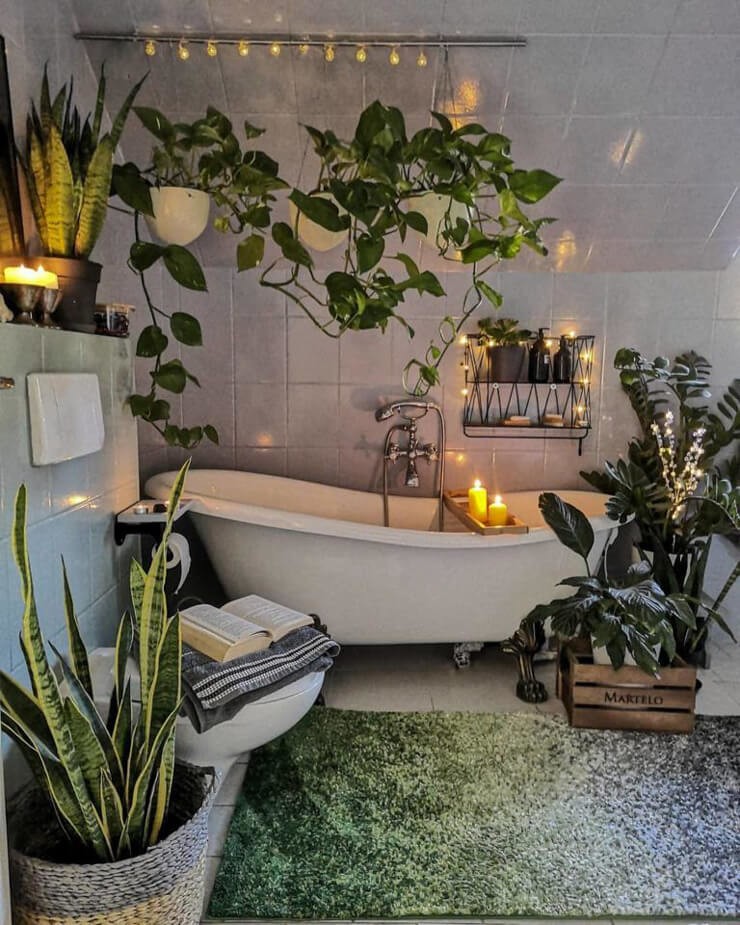 Bathroom filled with tall green plants and a green rug