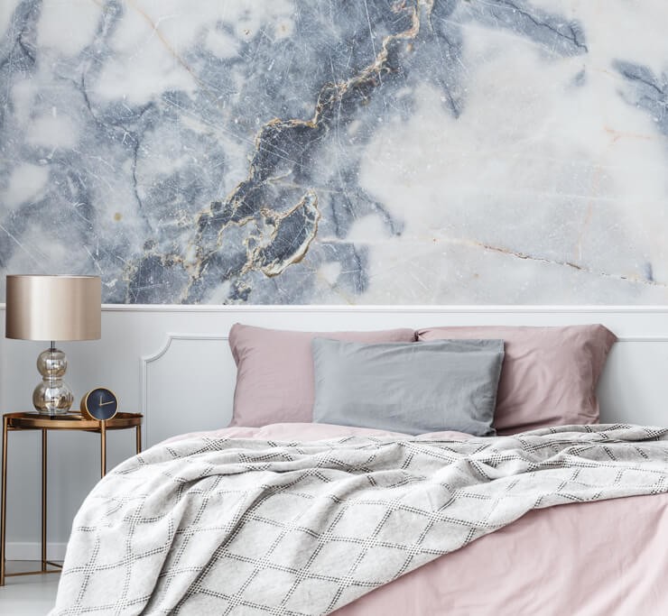 blue and off-white marble effect wallpaper in pink and white bedroom