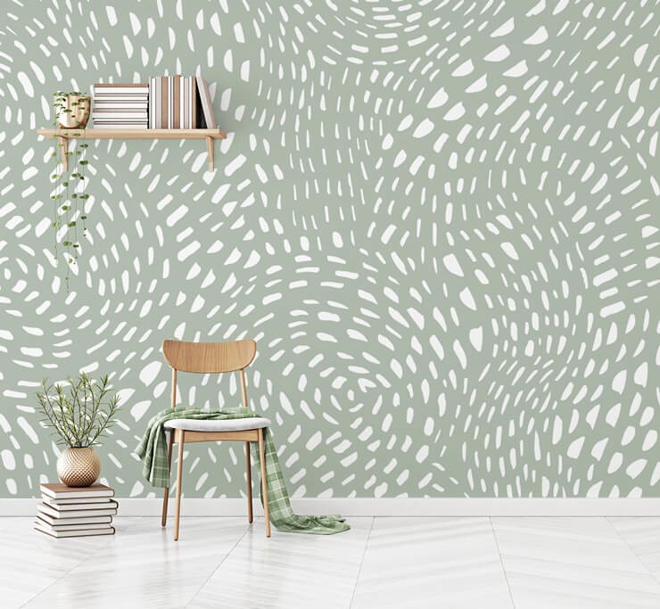 grey and green toned dotty wallpaper in room with floating shelves and chair