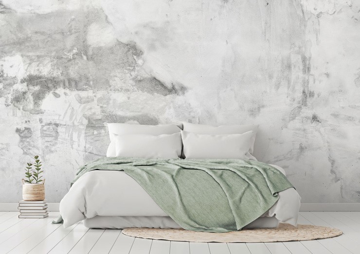 grey and white plaster effect wallpaper in bedroom with white and grey duvet covers