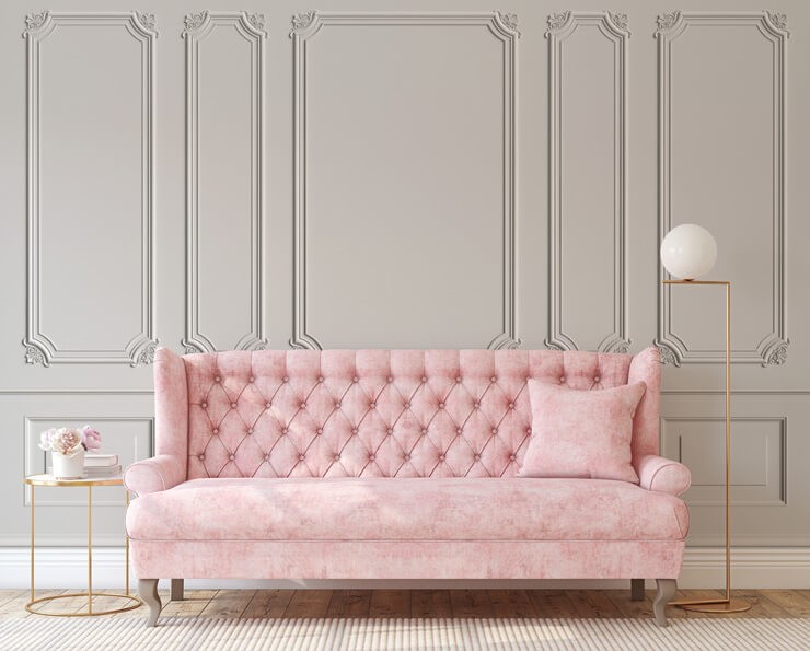 Classic cream wood effect panel wallpaper with a blush pink sofa
