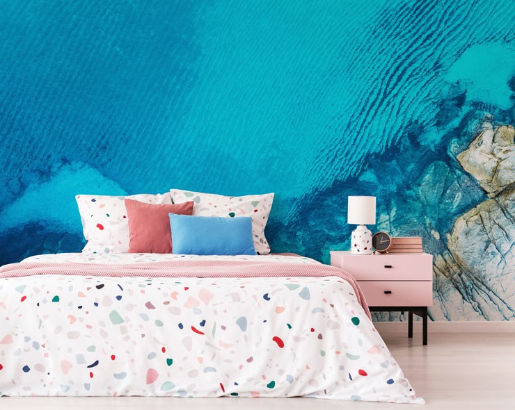 sapphire blue waters aerial view of coast with terrazzo patterned bed
