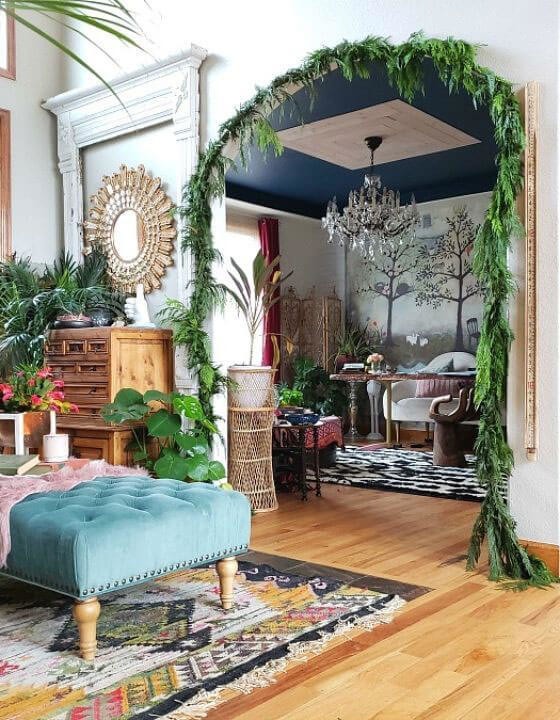 Eclectic interiors showing a living room with botanical plants, a blue ceiling and wooden flooring
