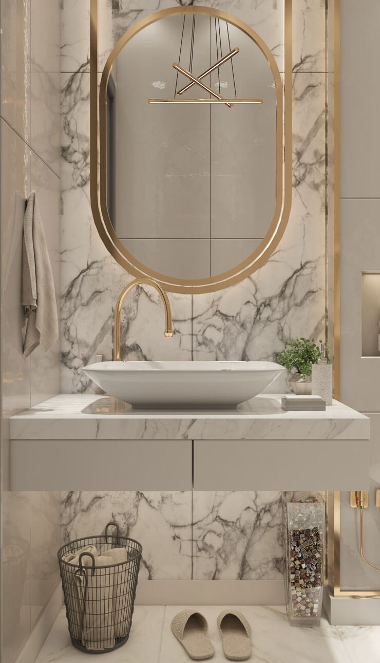 marble tiles, white sink and gold mirror