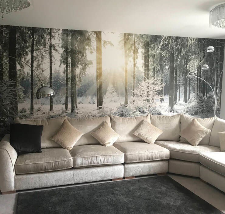 Misty forest wall mural in black and white with a light cream sofa and dark grey rug