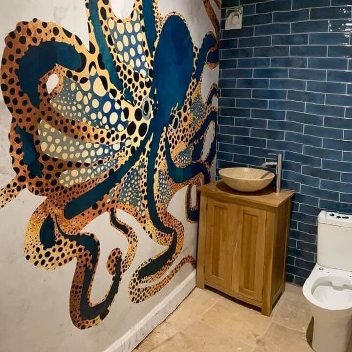 Blue octopus wallpaper in modern bathroom