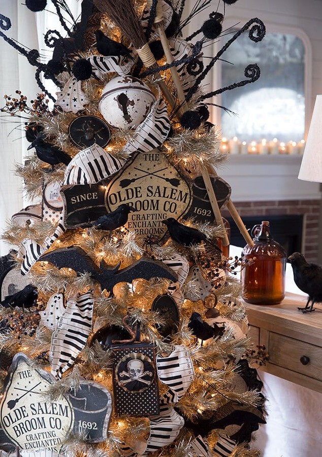 Christmas tree decorated for Halloween with black and white witch accessories