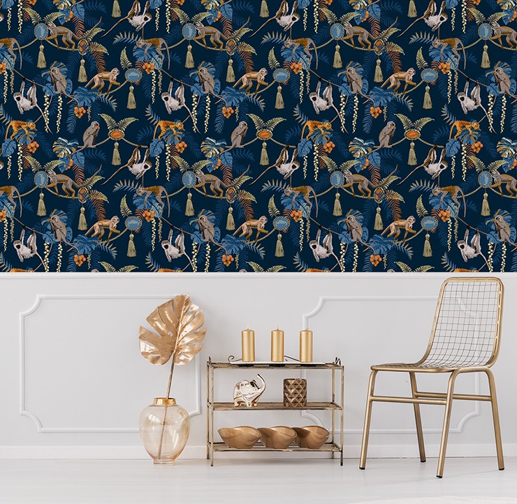 nay wallpaper with monkeys and orange jewels illustrated on it in lounge with white panels and gold accessories