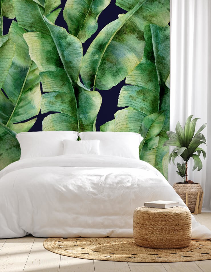 large green leaf wallpaper with bed with white bedding