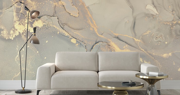 Stone grey marble effect wallpaper with a grey sofa and golden accents
