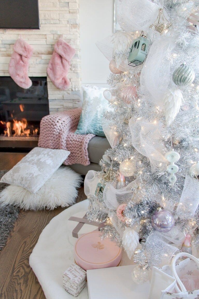 Pastel themed christmas decorations in a living room and on a tree
