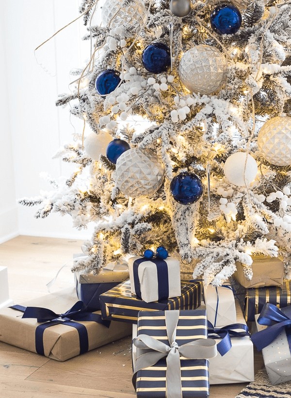 frosty christmas tree decorated with blue and silver accessories
