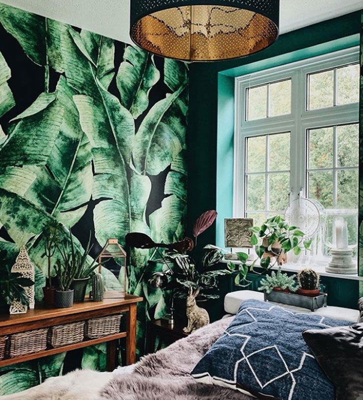 green tropical leaves wallpaper in forest green painted bedroom