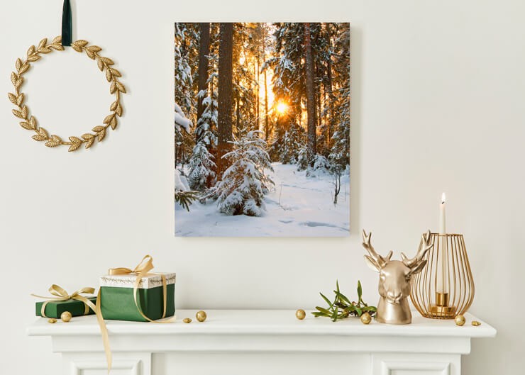 gold toned forest poster on metal above christmas fireplace