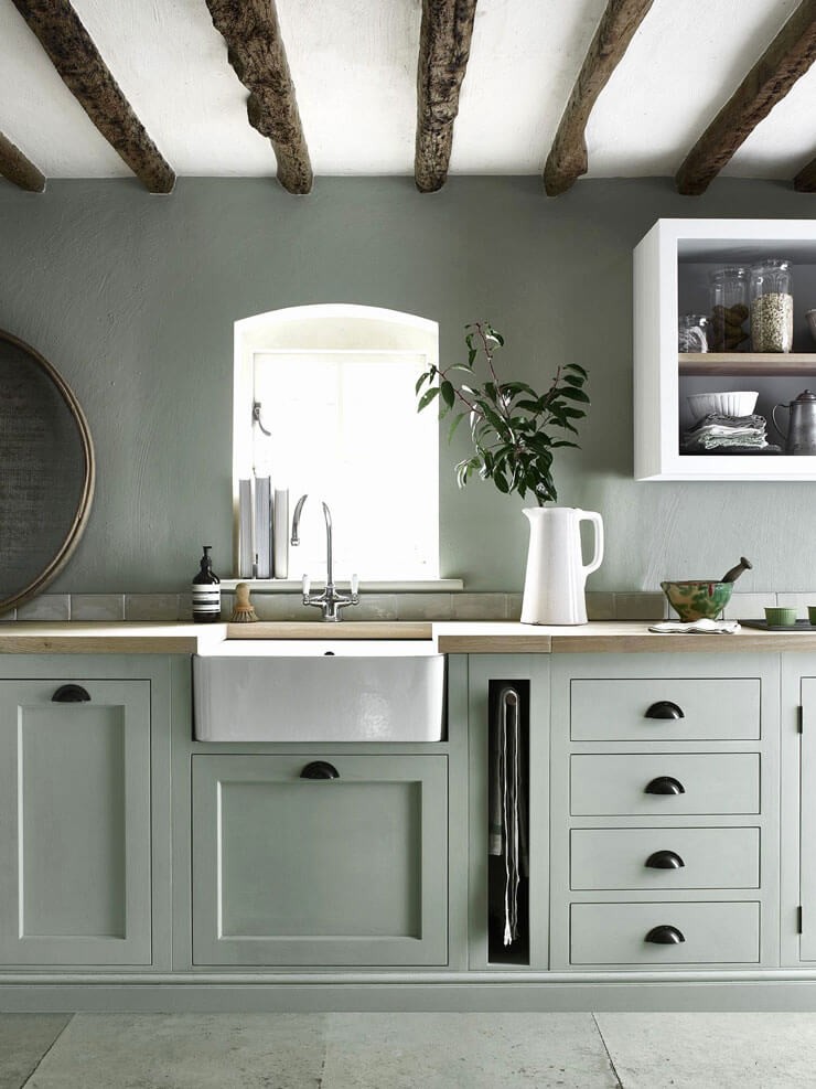 sage green painted kitchen with farmhouse sink