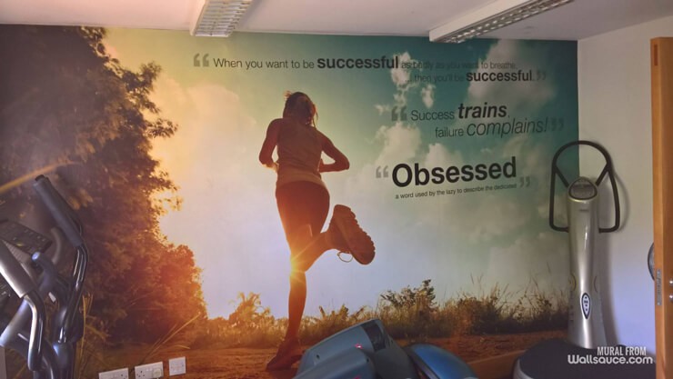 mural of lady jogging with motivation quotes wallpaper in small gym