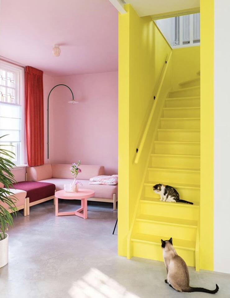 yellow painted stairs in a pink living room