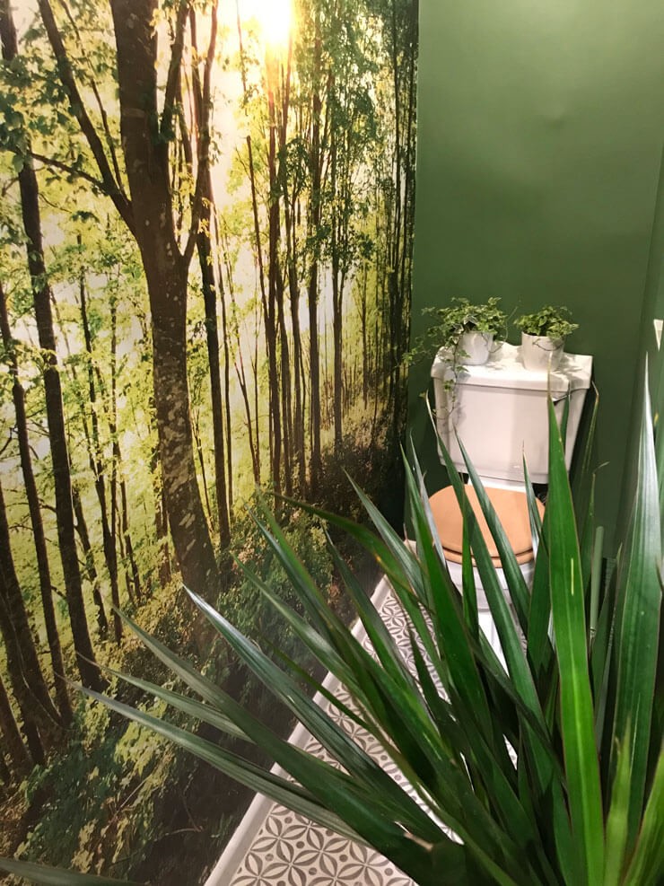forest wallpaper in small green toilet room