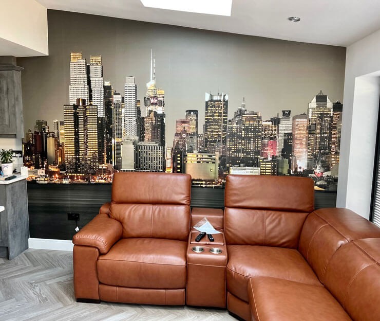 Realistic New York City wall mural behind a large brown sofa