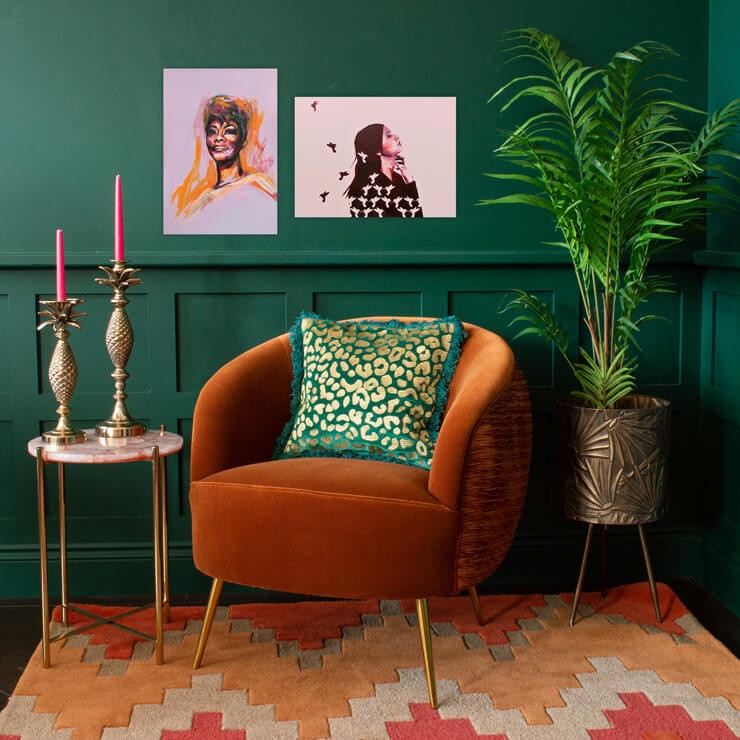 how to decorate with orange living room with orange armchair and green walls