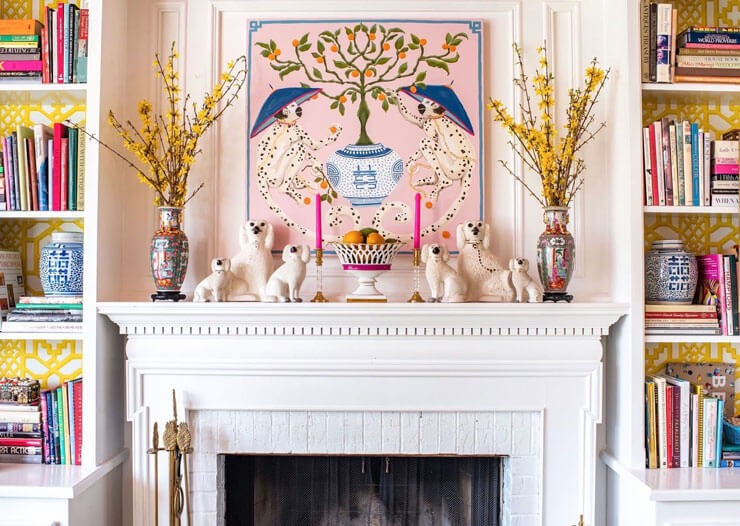 vintage mantelpiece decorated with antiques and colorful candles and vases