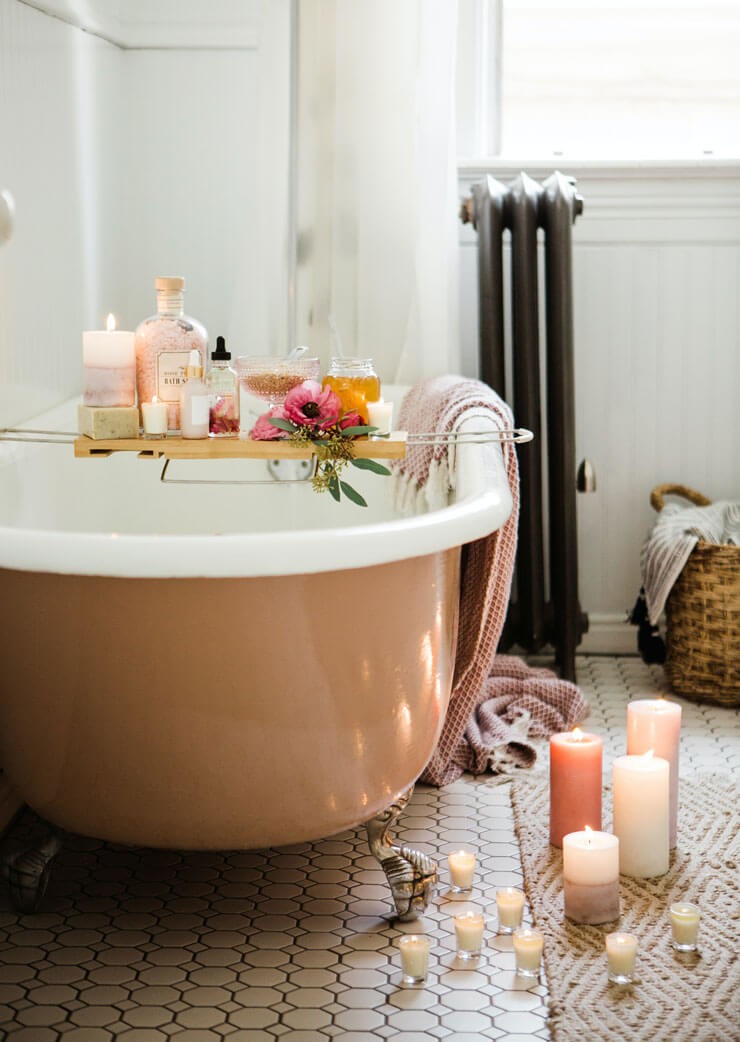 old bath tub decorated with pampering items