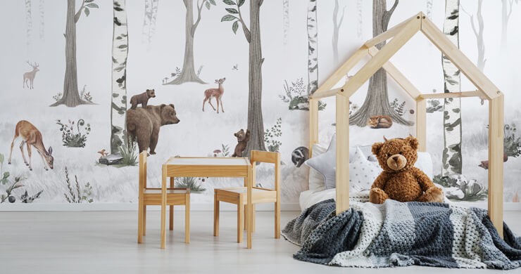 Kids' room trends 2023 with a woodland wallpaper with woodland animals and a pine bed frame