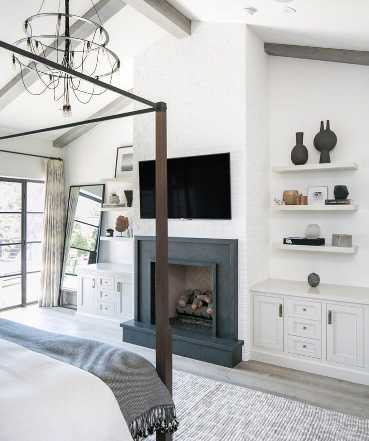 black fireplace in neutral bedroom