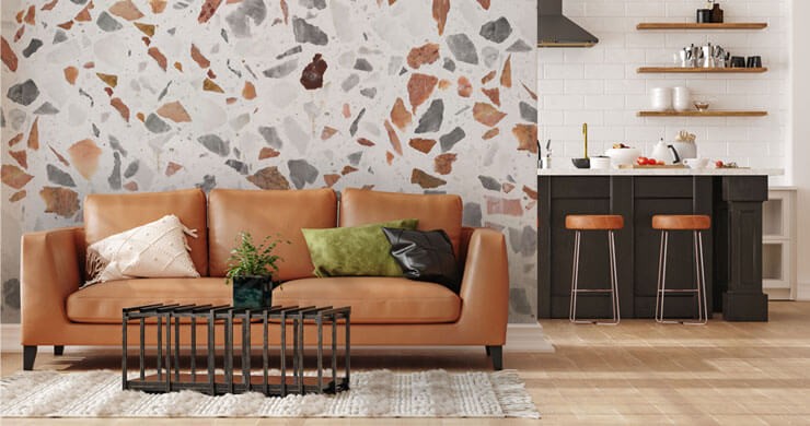 Living room trend for 2023 with a caramel terrazzo mural with a brown couch