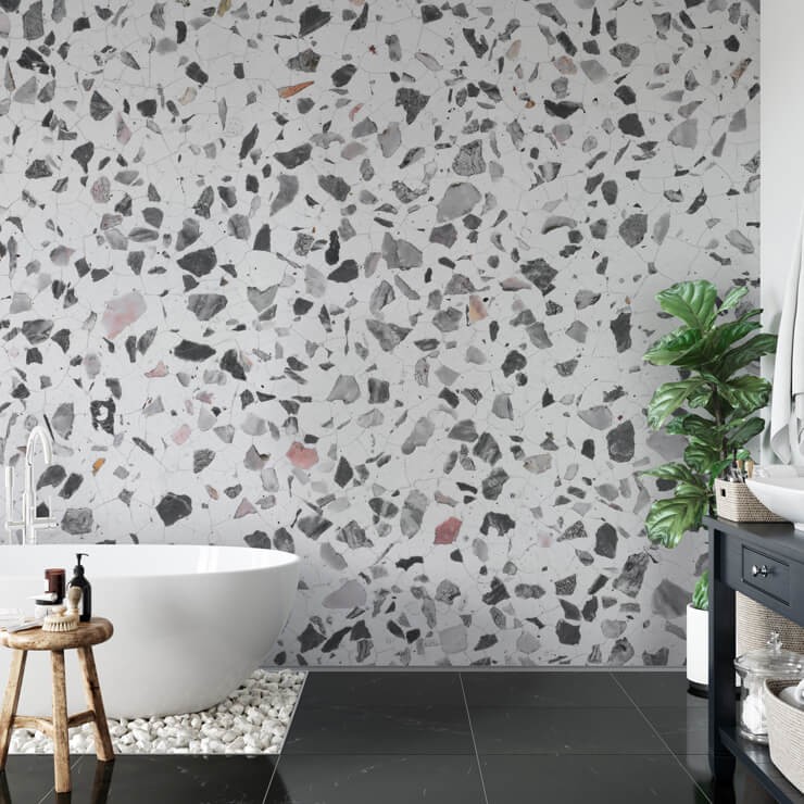 Modern bathroom with black stone floor and black and white terrazzo wallpaper