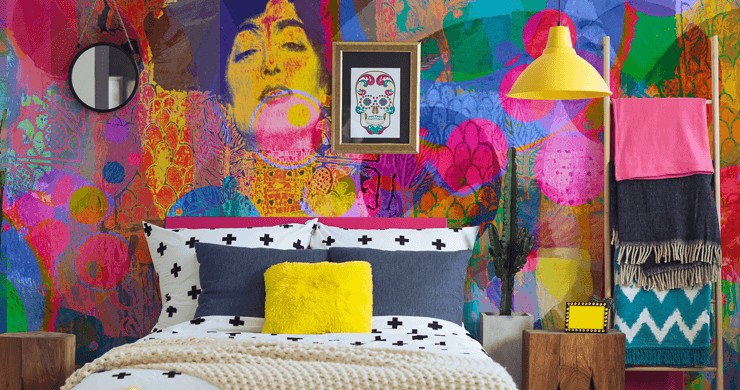 Electic interiors showing a bedroom with a bright wallpaper mural and bright yellow accessories 
