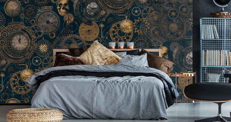 Blue and gold steampunk wallpaper in a bedroom with blue bedsheets