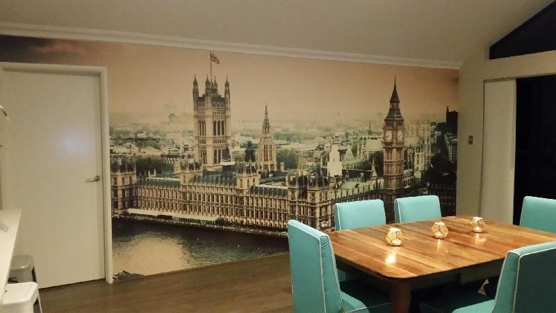 house of parliament wallpaper in dining room with blue chairs