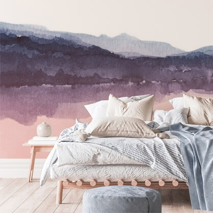 purple and pink watercolor mountains wallpaper in minimalist bedroom